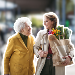 Junge Frau begleitet ältere Dame mit Einkaufstasche auf der Straße – Symbolbild für Online-Pflegekurse für Nachbarschaftshilfe | © PflegeBetreuer | unabhängige Pflegeberatung